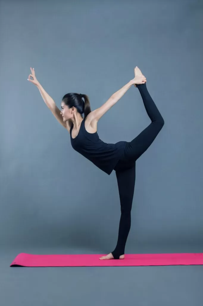 Woman standing on one leg in a Yoga pose