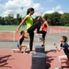 A woman exercising with children.