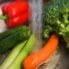 washing colorful vegetables celery and carrots.