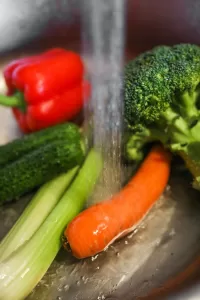 washing colorful vegetables celery and carrots.