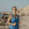 Woman jogging at the beach.