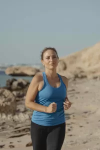 Woman jogging at the beach.