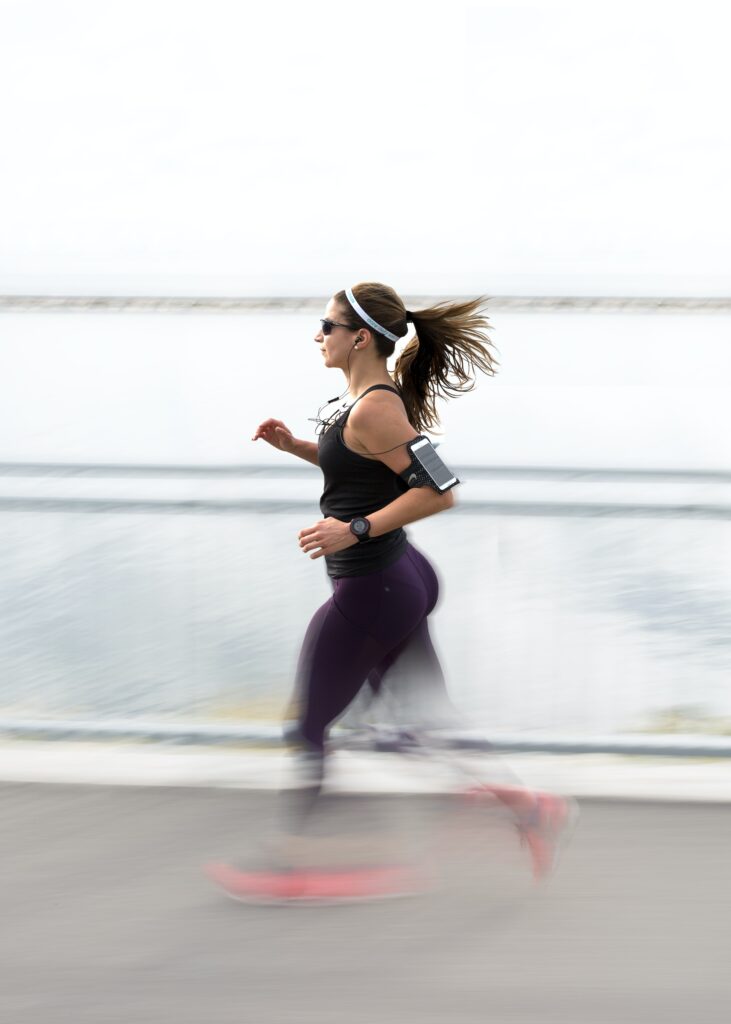 A young woman jogging using physiology exercise.