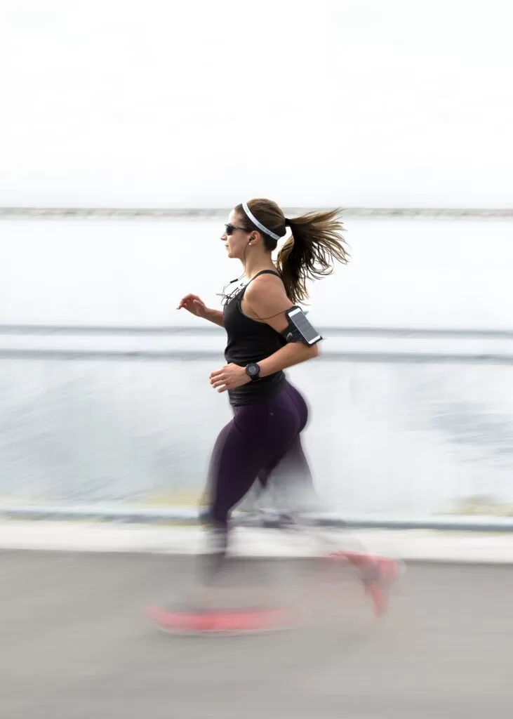 A young woman jogging using physiology exercise.