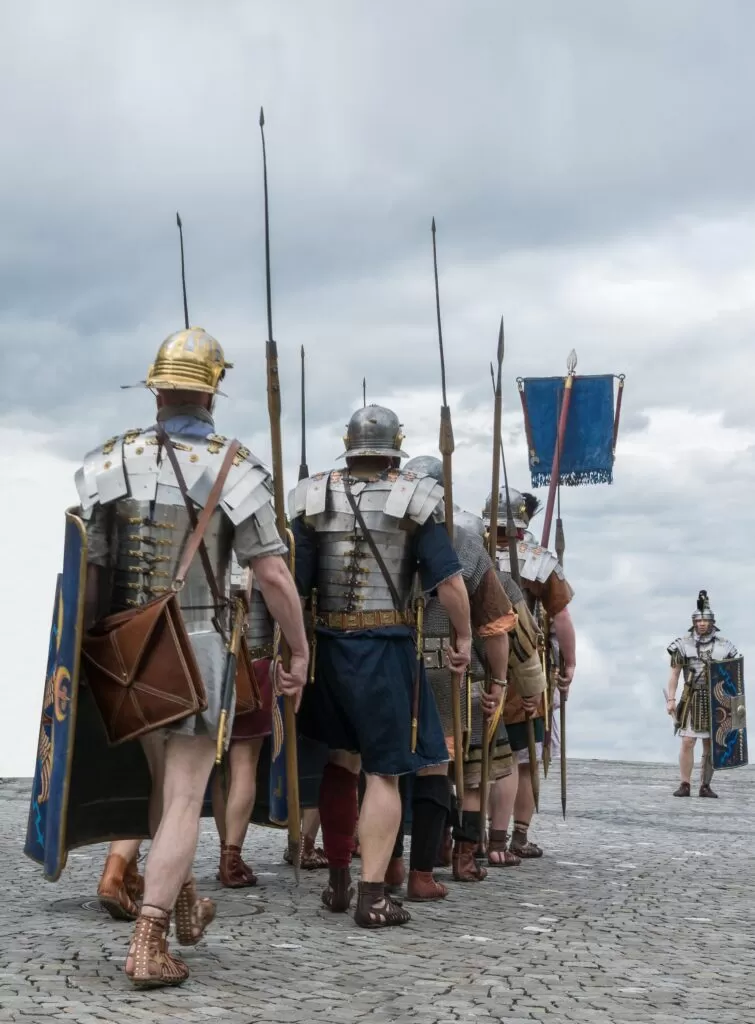 Roman soldiers marching, shields and spears.