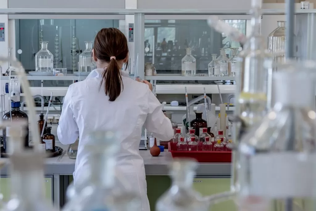 A female lab technician in the laboratory analyzing chemistry.