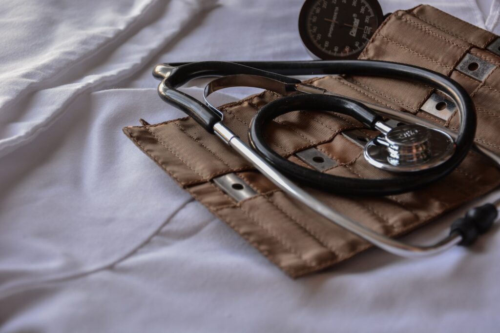 A blood pressure gauge resting on a bed.