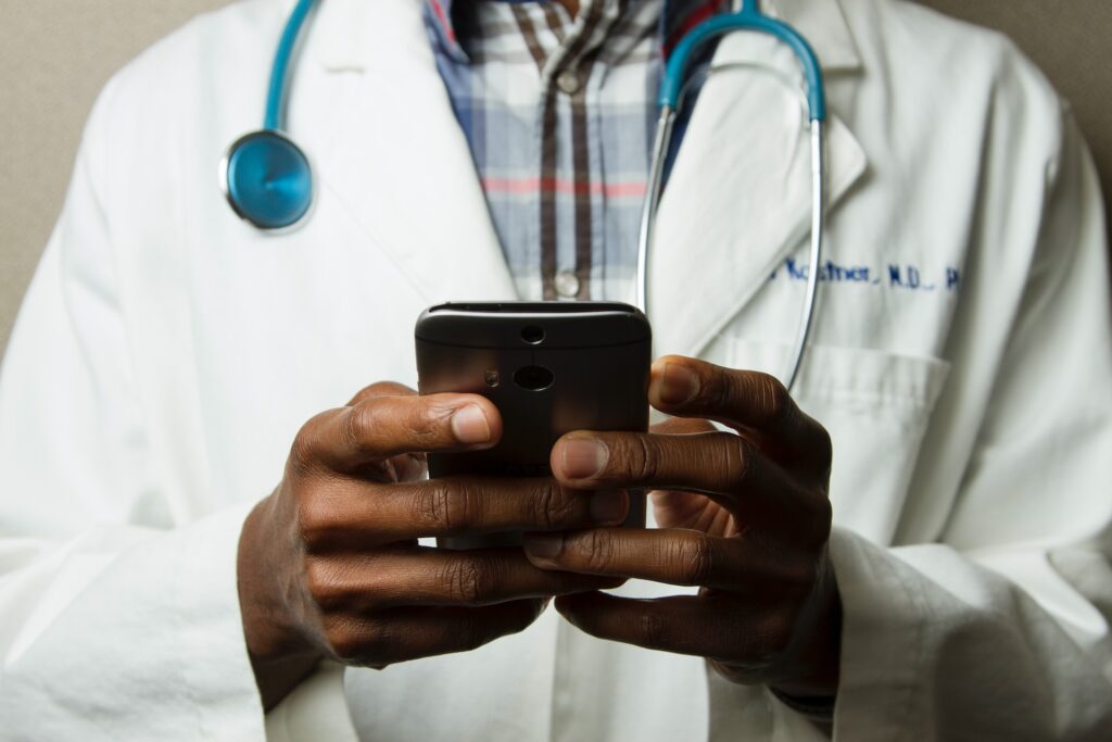 A man with a stethoscope around his neck using the Apple Health app.