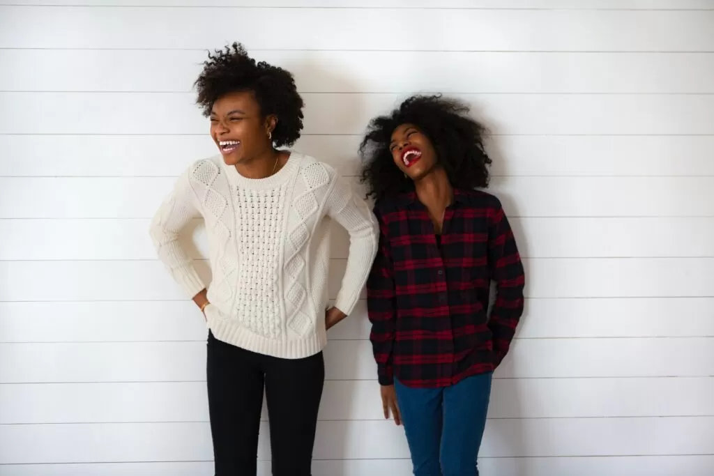 Two women laughing and smiling.