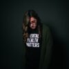 A woman wearing a black tee shirt with the words mental health matters on the front of it.