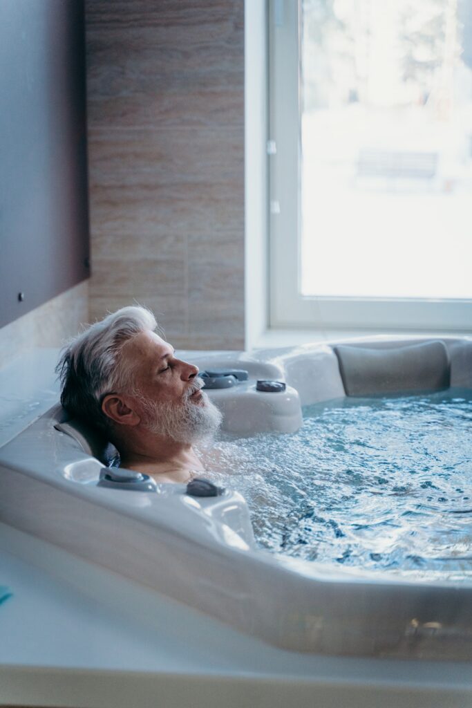 A bearded man relaxing in a hot tub.