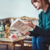 A woman reading limiting belief book.