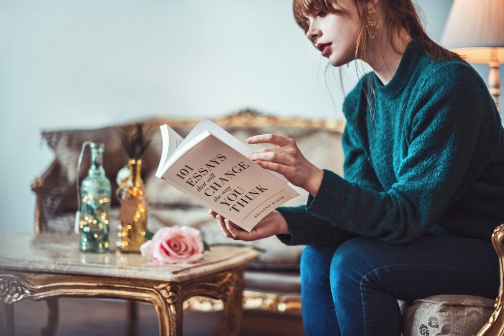 A woman reading limiting belief book.