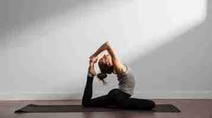 Woman practicing Hatha yoga on the floor in yoga position.