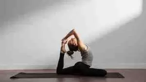 Woman practicing Hatha yoga on the floor in yoga position.