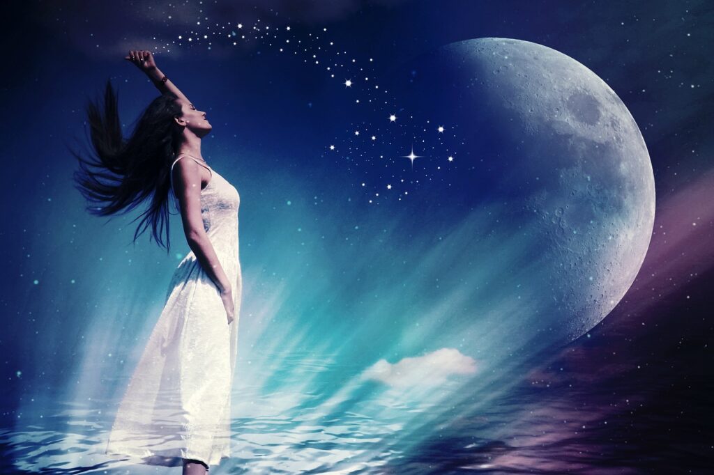 A woman manifesting and using the Law of Attraction staring at the moon.