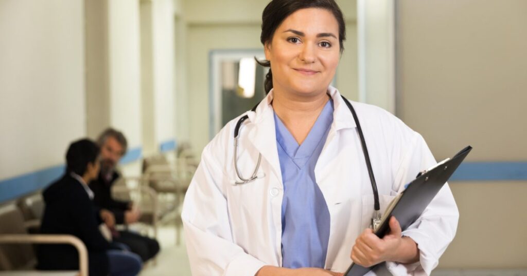 a-doctor-smiles-while-holding-her-clipboard