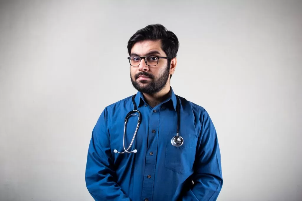 man in blue dress shirt wearing black framed eyeglasses