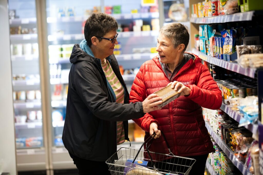 two woman smart grocery shopping for meal preparation for seniors