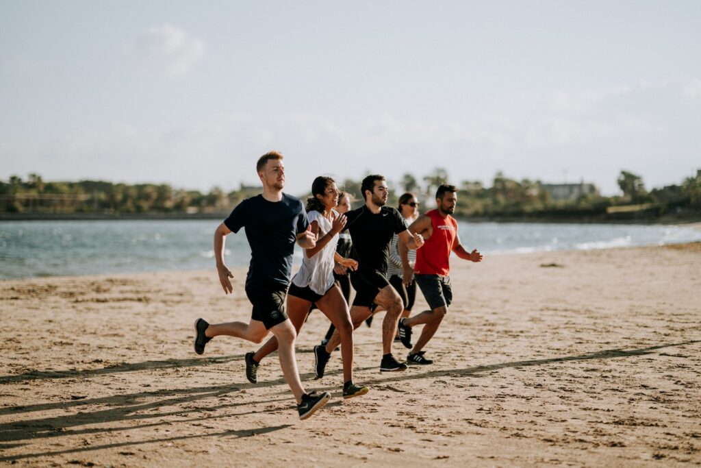 Physical activities performed by men and women running on the beach shore