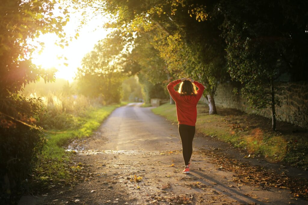 a woman walking on pathway during morning exercise program