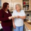 two women standing in a kitchen next to each other