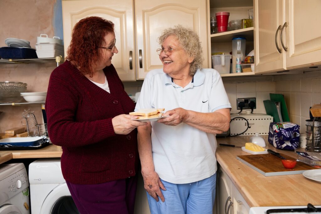 two women standing in a kitchen next to each other