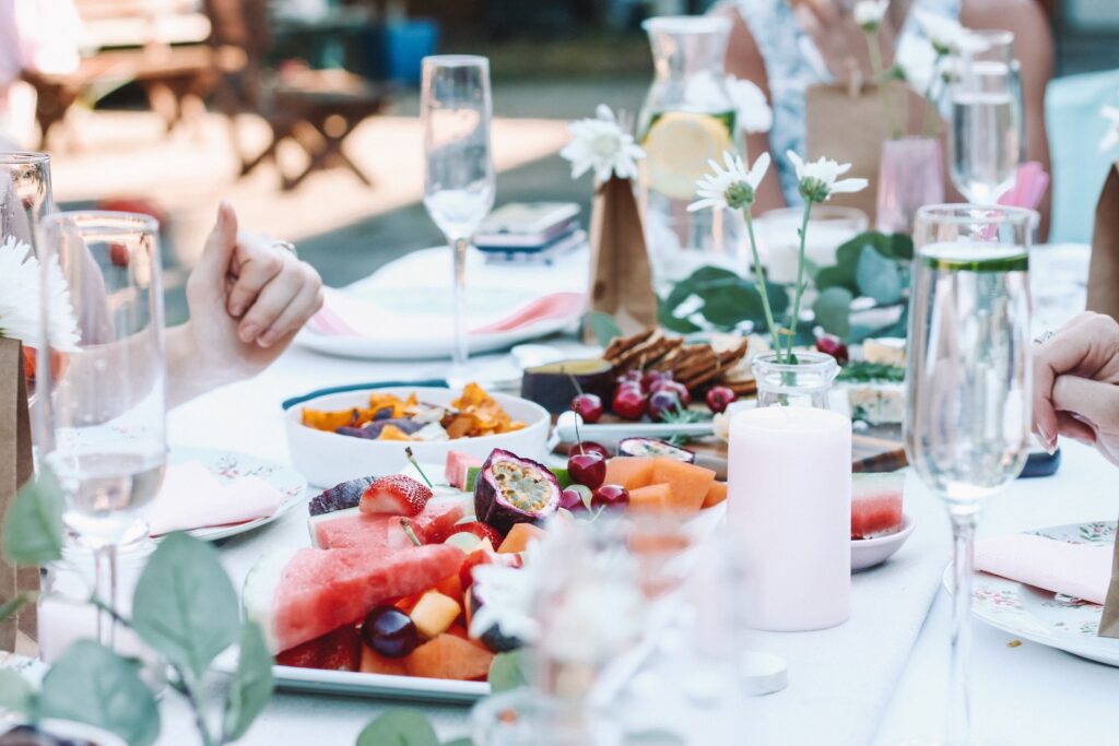 A dinner table with food groups on white dinner plates